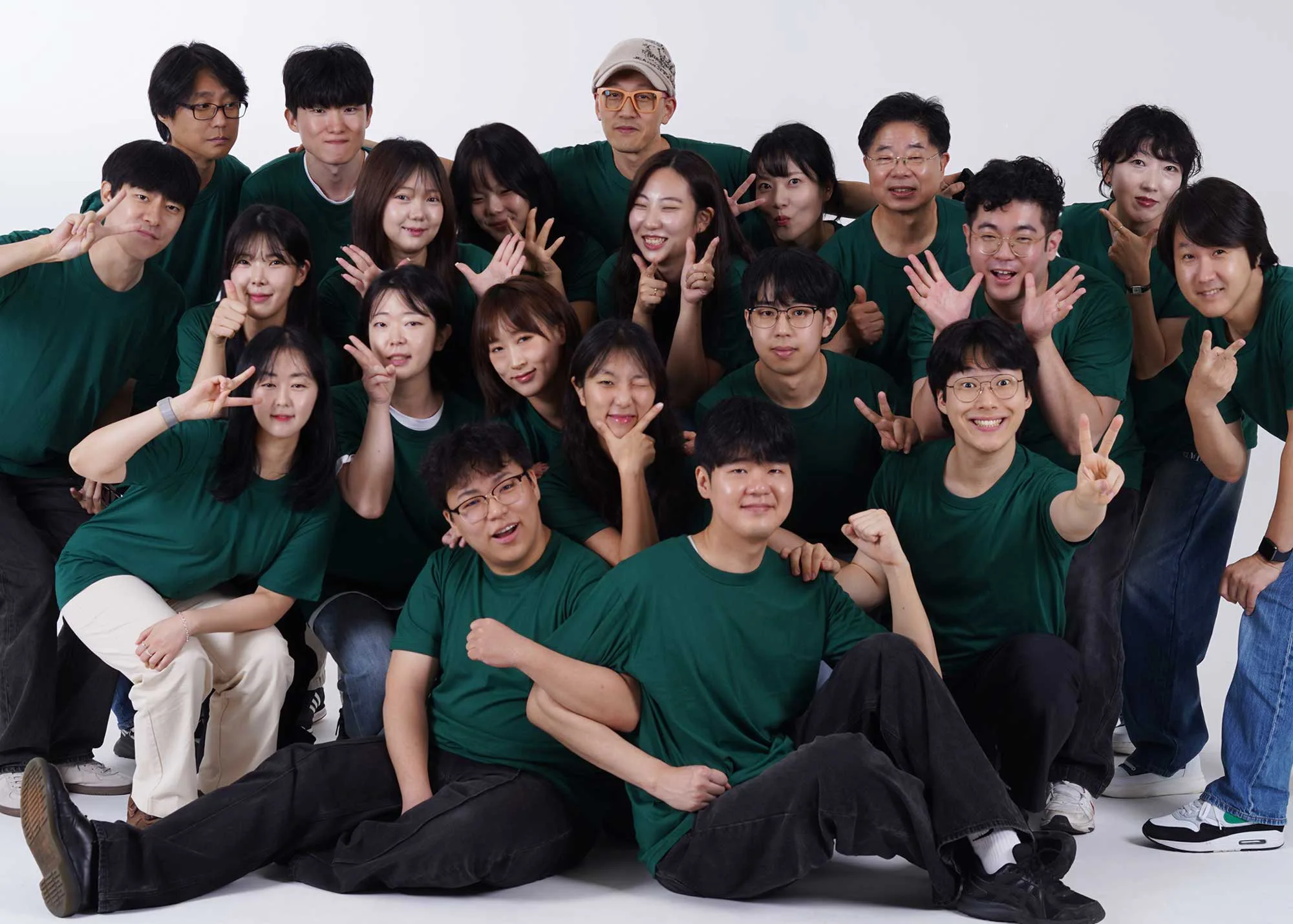 Gloim team group photo wearing green shirts in a studio — digital marketing and creative agency members smiling together